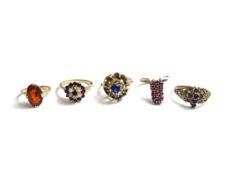 A gold, opal and garnet set cluster ring, a 9ct gold, blue and colourless gem set cluster ring and three further gem set ring