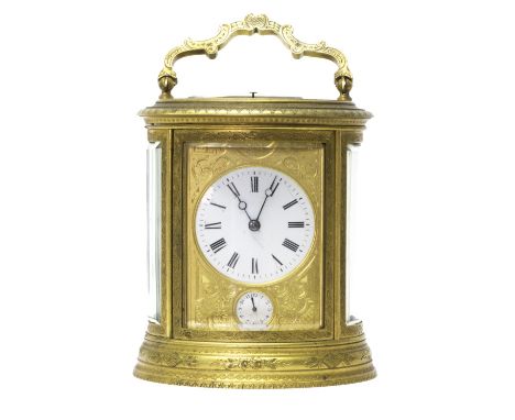 A French Petite Sonnerie oval carriage clock, late 19th century, with foliate engraved brass case surmounted by a shaped hand