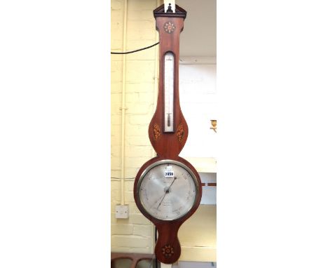 An Edwardian mahogany wheel barometer by J.Cetti and Co with brass urn finial and broken arch pediment over thermometer and e