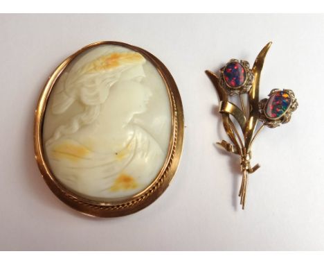 A gold mounted oval shell cameo brooch, carved as the portrait of a lady, within a wirework border and a gold and opal double