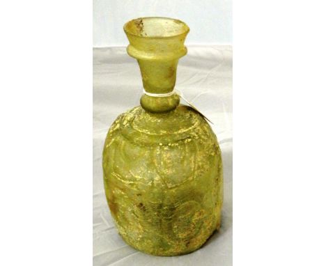 An intact clear glass flask, Iran, 10th century, with rounded body, ringed flaring mouth, and everted rim, the mould-blown de