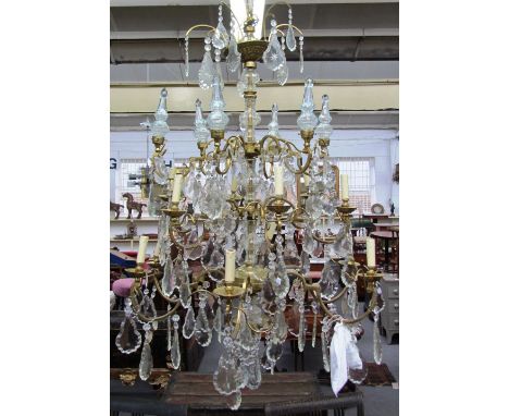 A French brass and glass lustre eighteen light chandelier, late 20th century, with two tiers of branches and a tier supportin