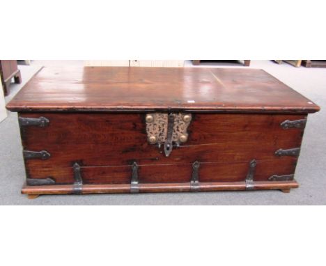 A large late 18th century iron bound rectangular teak trunk with side carry handles, 149cm wide. 