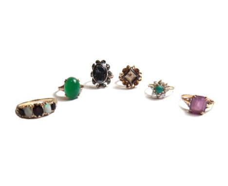 A 9ct gold, opal and garnet set five stone ring, a 9ct gold ring, claw set with a square cut smoky quartz, a gold, turquoise 