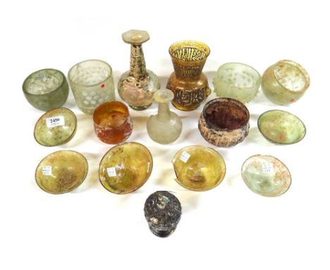 A group of Persian glass, mostly 9th-12th century, including two wheel-cut bottles; a wheel-cut beaker and bowl; a bowl with 