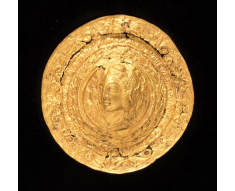 A Hellenistic style repoussé gold based alloy roundel, decorated in high relief with a portrait of a clasical young woman or 