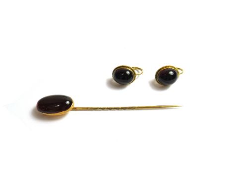 A gold and carbuncle garnet set single stone stick pin and a pair of carbuncle garnet set single stone earrings, each garnet 