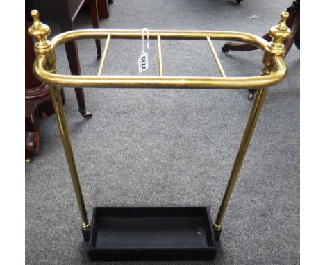 A Victorian style brass and cast iron four division stick stand, early 20th century, with turned finials and a rectangular ba