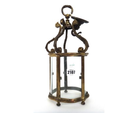A gilt metal Edwardian style hall lantern of shaped form, with scroll surmounts and loop finial, 33cm high.