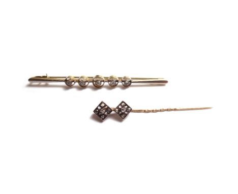 A gold and diamond set five stone bar brooch, collet set with a row of cushion shaped diamonds, graduating in size to the cen