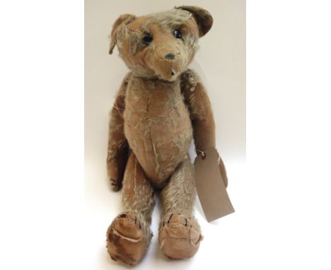 A Steiff teddy bear, circa 1910, with hump back and jointed limbs (a.f), 52cm high.