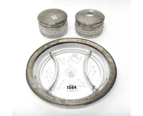 A Sterling mounted triple division glass circular dish, having a decorated border, a silver lidded faceted glass hair tidy ja