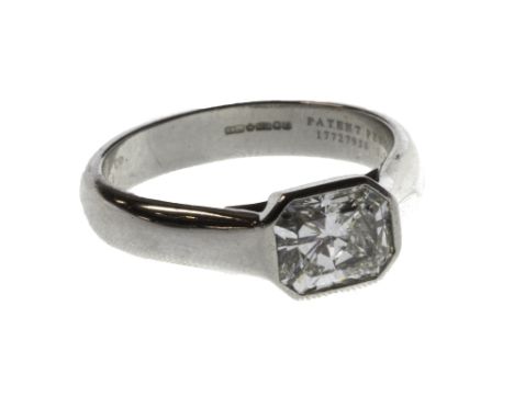 A Tiffany & Co platinum and diamond set single stone ring, mounted with a cut cornered rectangular mixed cut diamond, in an u