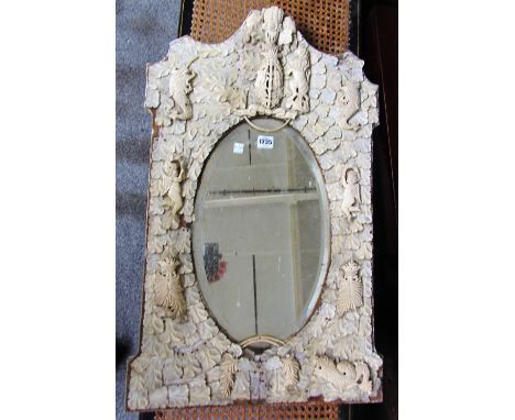 A 19th century Dieppe carved ivory arch top wall mirror, the oval plate in an oak leaf carved border, mounted with armorial l