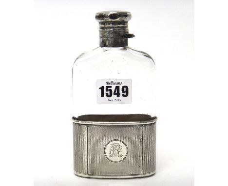 A late Victorian silver mounted spirit flask, of curved rectangular form, with engine turned decoration, with a pull-off beak