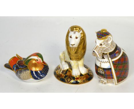 Three Royal Crown Derby paperweights, a heraldic lion designed by Louise Adams, limited edition no.1681/2000 with octagonal g