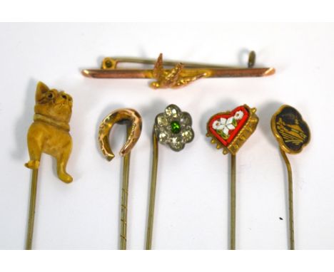 Five Edwardian stick pins, one with a dog finial, one yellow metal with a horseshoe finial, one with a heart shaped micro mos