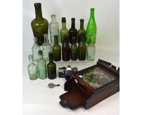 A modern thirty day mahogany wall clock, a cased Praktica camera and a quantity of vintage bottles to include R. Whites and D