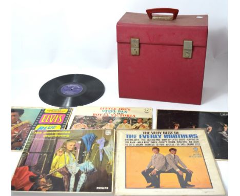A red record case containing a quantity of vinyl to include The Rolling Stones, Buddy Holly, The Everly Brothers etc.