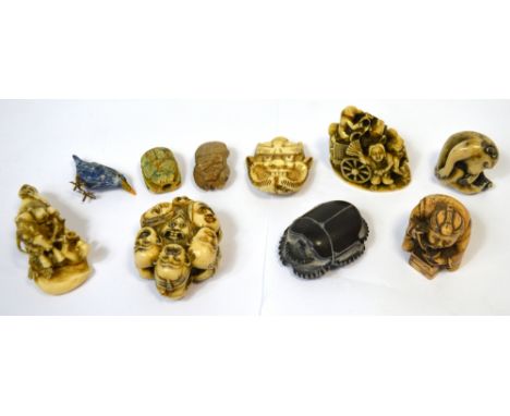 A vegetable ivory mask decorated netsuke, 6cm, a resin netsuke, four small okimonos, three scarabs and a polished stone figur