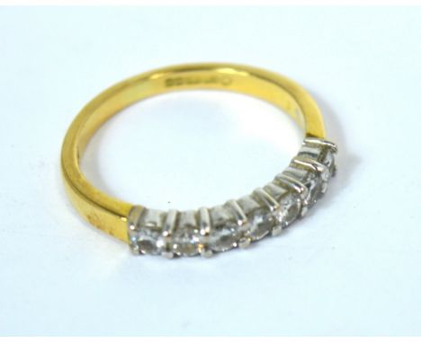 An 18ct gold half eternity ring with seven small white diamonds, size K, 2.9g.