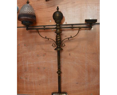 A bronzed two branch lamp, lacking one shade, height 88cm.