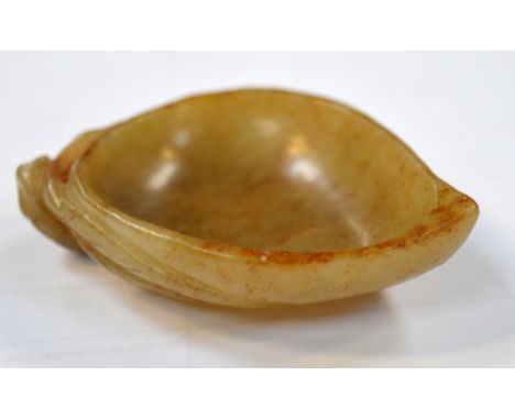 A Chinese carved russet included jade shallow bowl modelled as a leaf, length 7.5cm. CONDITION REPORT Very small rim chip.