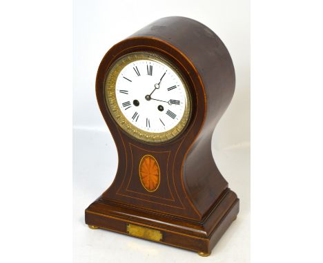 An Edwardian mahogany satinwood inlaid and boxwood strung balloon shaped mantel clock with circular white enamel dial set wit
