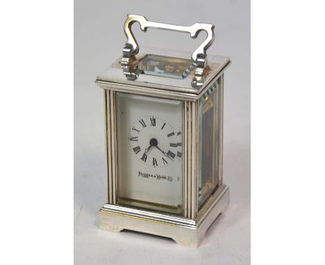 A Mappin & Webb white metal carriage clock of small proportions, the enamel dial set with Roman numerals, height 8cm.