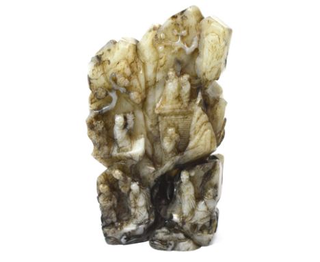 An 18th century Chinese black and grey carved jade boulder depicting Xi Wangmu and eight immortals upon a mountainside, heigh