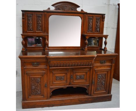 An Edwardian mirror back sideboard with shelf to either side over two drawers above two cupboard doors and two central cupboa