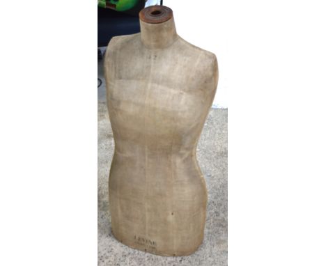 An early 20th century French linen covered mannequin, 'Levine' London-Paris, height 85cm, comes with a non-matching circular 