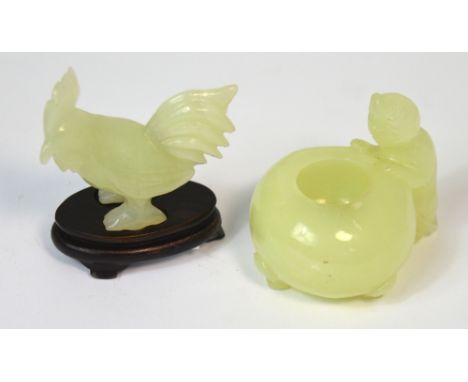A Chinese carved jade ink pot modelled as a cat peering into the pot, length 5.75cm and a further carving of a cockerell on s