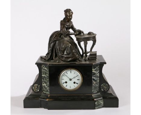 Victorian black slate and marble mantel clock, with a lady seated at a table surmounting the clock base, a white enamel dial 