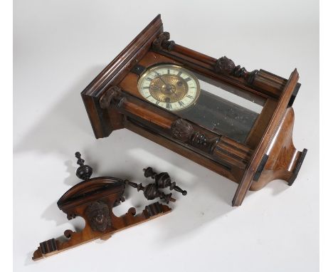 Walnut veneered wall clock, with mask and turned spindle pediment above an ivorine dial with Roman numerals, 31cm wide, 66cm 
