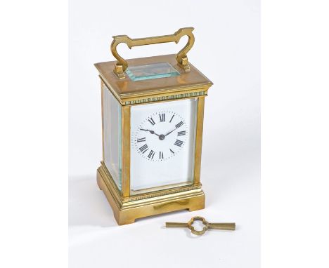 French brass cased carriage clock, the white enamel dial with black roman numerals (AF), with key, 12cm high