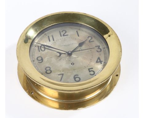 U.S. Government clock, by Chelsea Clock Company Boston, having brass circular case housing a silvered dial with arabic numera