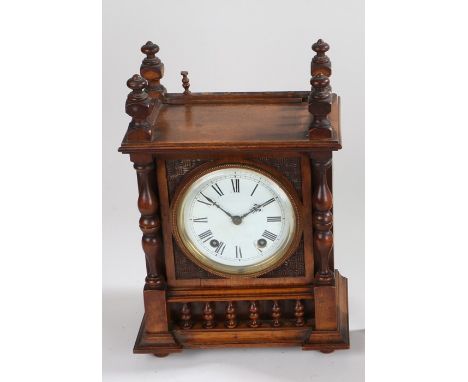 Edwardian walnut mantel clock, the white enamel dial with Roman numerals, flanked by turned pilasters, 26cm wide, 36cm high