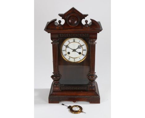 Edwardian mantel clock, the pediment with turned finials and dished centre, the white enamel dial with Roman numerals, the gl