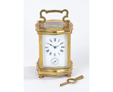 French brass cased carriage clock, having shaped case enclosing a white enamel dial with black roman numerals, with key, 12cm