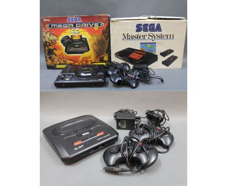 A 1990 Sega Mega Drive console with controllers, a Sega 16-bit Mega Drive II console with control & charger, a boxed Sega Mas