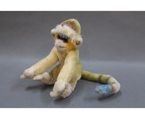 A Steiff "Mungo" multi-coloured monkey, having no button, measuring 17cm high