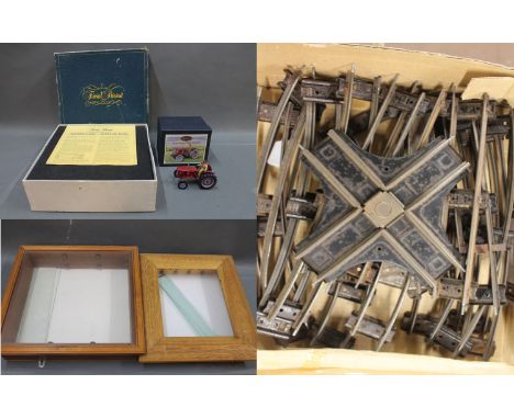 A boxed Trivial Pursuit game, a Britain's Collectables vintage farm David Brown 900 tractor model, a box of 0 gauge track and