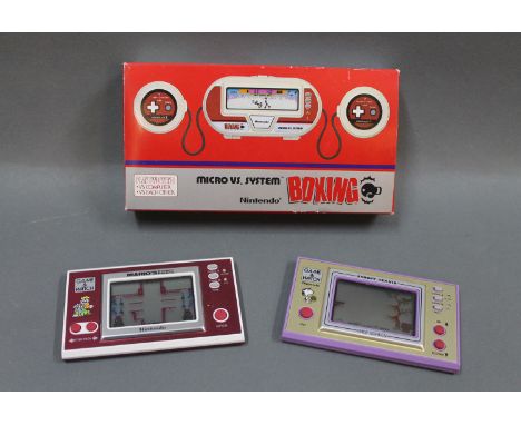 A 1980's boxed Nintendo Micro vs.System boxing game, a Nintendo game and Watch Mario's Cement Factory hand held game and a Ni
