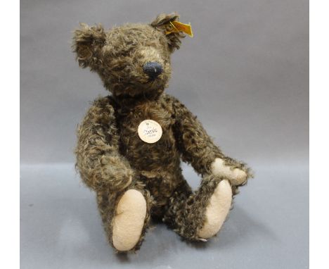 A Steiff Classic teddy bear, having button to the ear and paper tag to the chest, measuring 33cm high