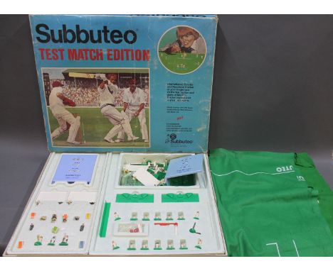 A boxed Subbuteo test match edition cricket game comprising 00 scale teams, playing pitch, wickets, bat, balls, etc