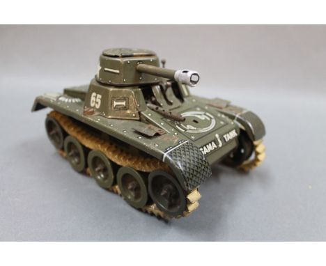 A DRGM tin plate Gama sparking tank, marked "Made in US zone of Germany" to the back and base. The rubber tread on the left h