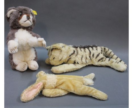 A 1960's Steiff "Cosy Raccy" Racoon, with lentil button and tag, measuring 20cm high, a Steiff floppy cat, with no button, me