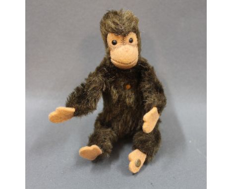 A 1960's Steiff brown "Jocko" monkey, with bendy limbs and raised script button, measuring 11cm high