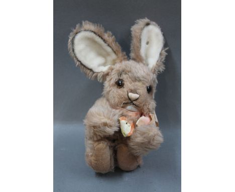 A Steiff Original 'Cosy Mummy' bunny rabbit, having metal script button and paper tag, measuring 17cm long